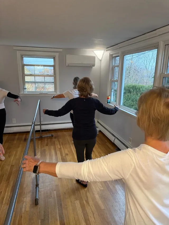 Adult students practising ballet positions at the barre during a private VW Dance class
